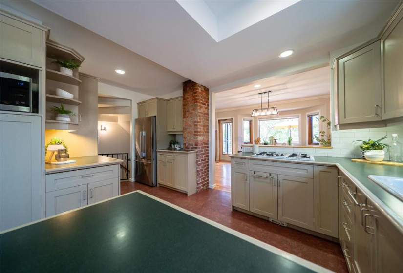 Kitchen with cork floor and original brick chimney.