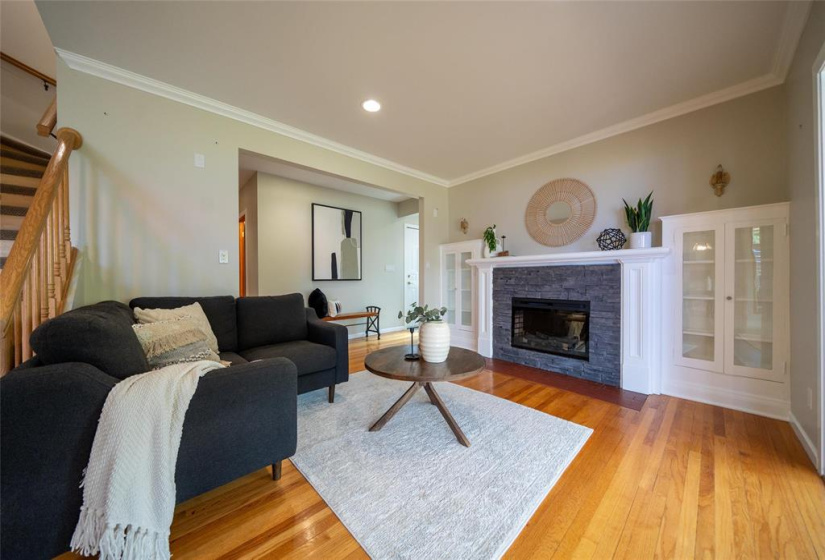 Open concept living room with electric fireplace.