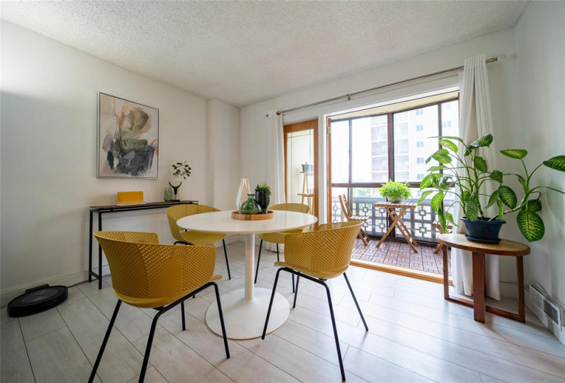 Dining area with doors out to balcony.