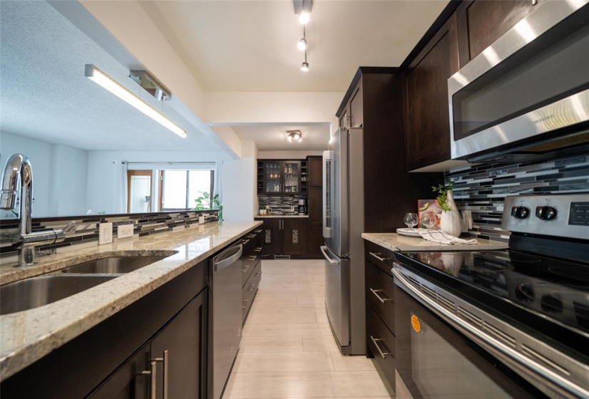 Tiled backsplash and espresso-stained maple cabinets.