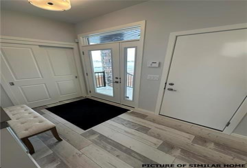 Front Foyer with a double closet. Inside door to the garage.