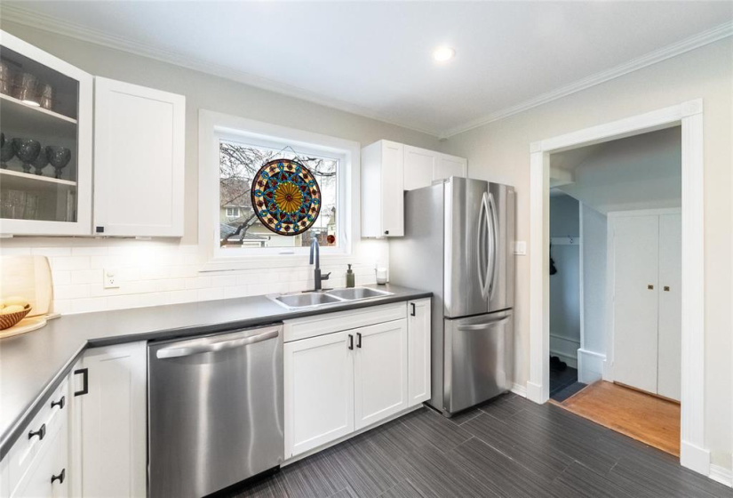 Garburator in sink. View to back door and basement entrance