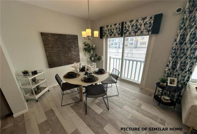 Dining area with sliding patio doors to future deck & back yard.