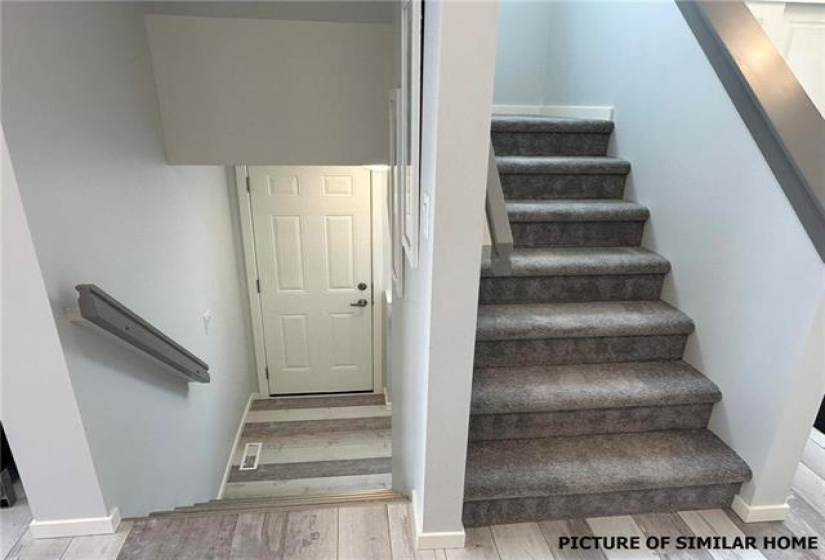 Stairs Up to the 2nd floor and down to the Bsmt with exterior side door