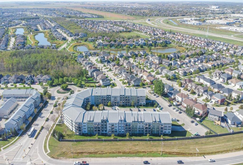 SUMMER AERIAL PHOTOS OF THE COMPLEX. SURROUNDED BY TONS OF $650,000-$1.3+ MILLION DOLLAR HOMES IN THIS GORGEOUS RESIDENTIAL AREA, THAT FEATURES LOTS OF BIKING/WALKING/RUNNING TRAILS, PARKS, PLAYGROUNDS AND A NEW SCHOOL!