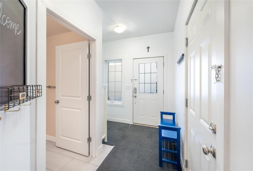 To the left is the powder room, to the right is the entrance to the garage.